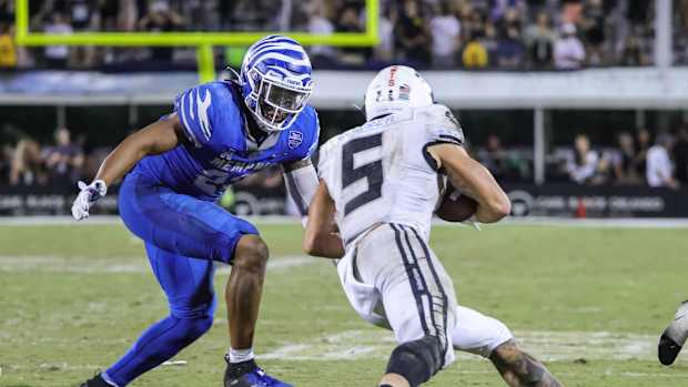 Oct 22, 2021; Orlando, Florida, USA; UCF Knights running back Isaiah Bowser (5) runs the ball as Memphis Tigers linebacker JJ Russell (23) move in during the second half at Bounce House. Mandatory Credit: Mike Watters-USA TODAY Sports